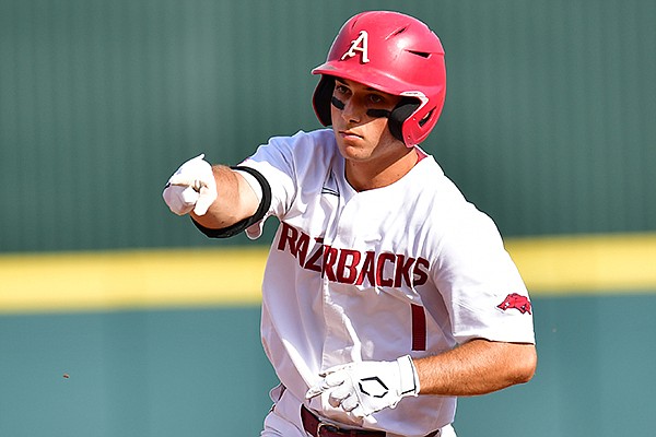 Arkansas second baseman Robert Moore runs the bases after hitting a home run during an NCAA super regional game against North Carolina State on Friday, June 11, 2021, in Fayetteville.