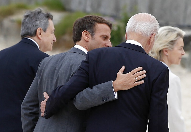 U.S. President Joe Biden speaks with French President Emmanuel Macron (second left) during arrivals for a G-7 meeting at the Carbis Bay Hotel in Carbis Bay, St. Ives, Cornwall, England, on Friday, June 11, 2021. (Phil Noble, Pool via AP)