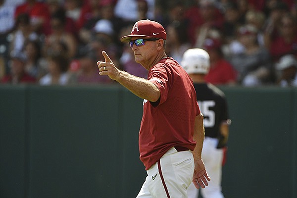 Arkansas coach Dave Van Horn heads to the mound to make a pitching change against North Carolina State in the fourth inning of an NCAA college baseball super regional game Saturday, June 12, 2021, in Fayetteville. (AP Photo/Michael Woods)