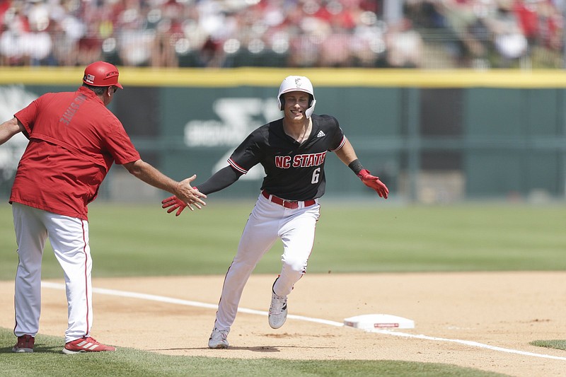 North Carolina State infielder Vojtech Mensik (6) runs home for a score, Saturday, June 12, 2021 during the fourth inning of the Fayetteville Super Regional at Baum-Walker Stadium in Fayetteville. Check out nwaonline.com/210613Daily/ for today's photo gallery. .(NWA Democrat-Gazette/Charlie Kaijo)