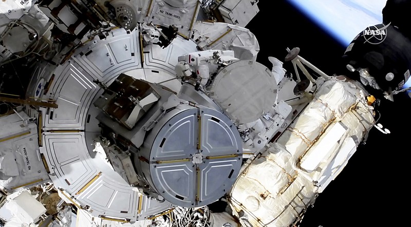In this image taken from NASA video, French astronaut Thomas Pesquet, top center, and NASA astronaut Shane Kimbrough venture out on a spacewalk Wednesday, June 16, 2021, to outfit the International Space Station with powerful, new solar panels to handle the growing electrical demands from upcoming visitors.  (NASA via AP)