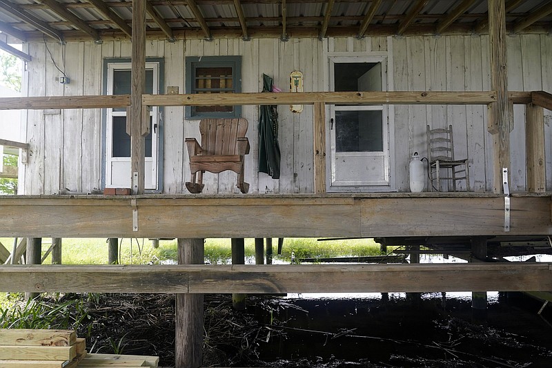 A rocking chair sits on the porch of an old trapper’s camp that has been restored and repurposed  by the McIlhenny Co., on Avery Island, La., where Tabasco brand pepper sauce is made.
(AP/Gerald Herbert)