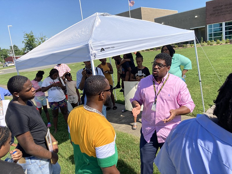 Sheriff Lafayette Woods Jr. (right) talks to a group of protesters Tuesday raising questions surrounding Dezmen McBride, 18, who died while in county custody. William Carter (center) is McBride’s stepfather, and Marqusie Carter (left) is McBride’s brother. 
(Pine Bluff Commercial/Byron Tate)