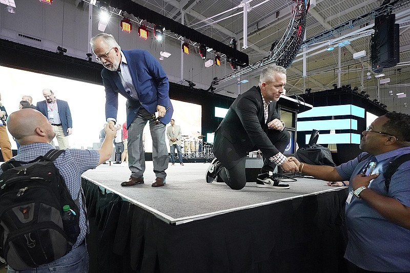 Onstage, incoming Southern Baptist Convention President Ed Litton (left) and outgoing President J.D. Greear talk with denomination members after the annual Southern Baptist Convention meeting Wednesday in Nashville, Tenn.
(AP/Mark Humphrey)