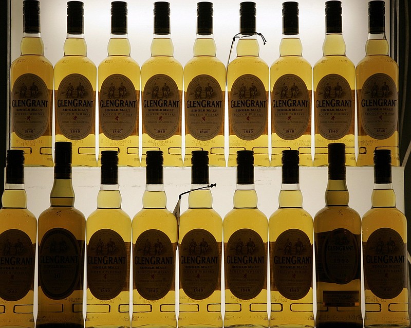 Bottles of Glen Grant whisky fill a display in Cologne, Germany, in this file photo. The U.S. has agreed to suspend tariffs on one of Scotland’s main exports. The 25% tariff on single malt Scotch whisky was part of a trade dispute between the U.S. and EU countries over aerospace subsidies.
(AP)