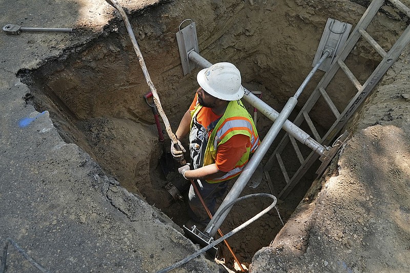 A water company worker removes a lead water-service line dating from 1927 and installs a new copper one Thursday at a private home in Denver. While President Joe Biden’s infrastructure bill proposes $45 million for eliminating lead pipes and service lines, some utility companies and municipalities have already started replacing them.
(AP/Brittany Peterson)