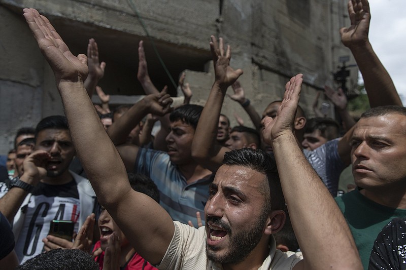 Palestinian mourners chant anti-Israel slogans Thursday during the funeral of Ahmad Shamsa, 15, in the West Bank village of Beta, near Nablus. The Palestinian health ministry said Shamsa was shot by Israeli troops Wednesday.
(AP/Nasser Nasser)