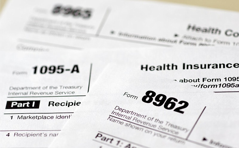 This Aug. 21, 2014, file photo shows health care tax forms 8962, 1095-A, and 8965 in Washington. (AP/Carolyn Kaster)