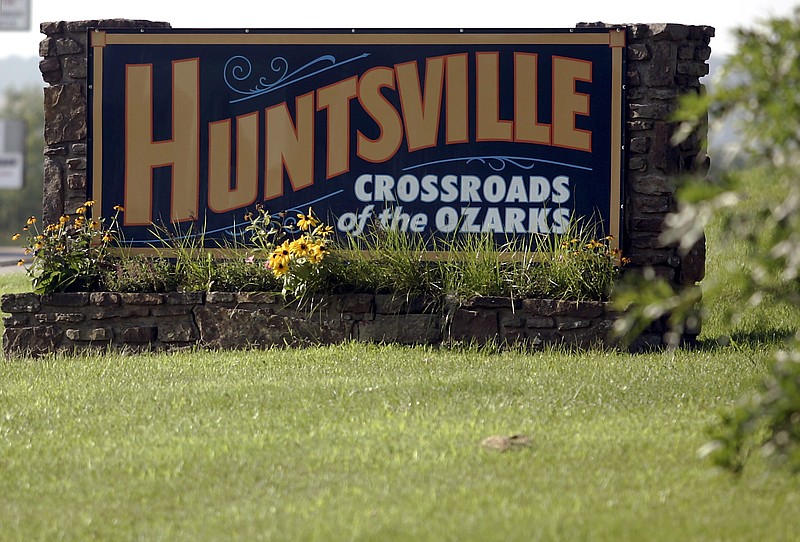 A sign labeling it as the "Crossroads of the Ozarks," welcomes visitors to Huntsville in Madison County. (Arkansas Democrat-Gazette FILE PHOTO)