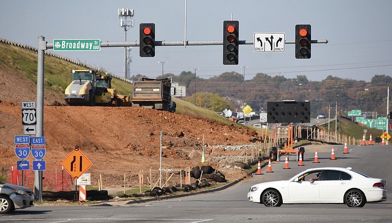 A car passes through the intersection of Broadway and North Locust Street on the east side of Interstate 30 as soil compactors work in this Nov. 6, 2020, file photo. (Arkansas Democrat-Gazette/Staci Vandagriff)