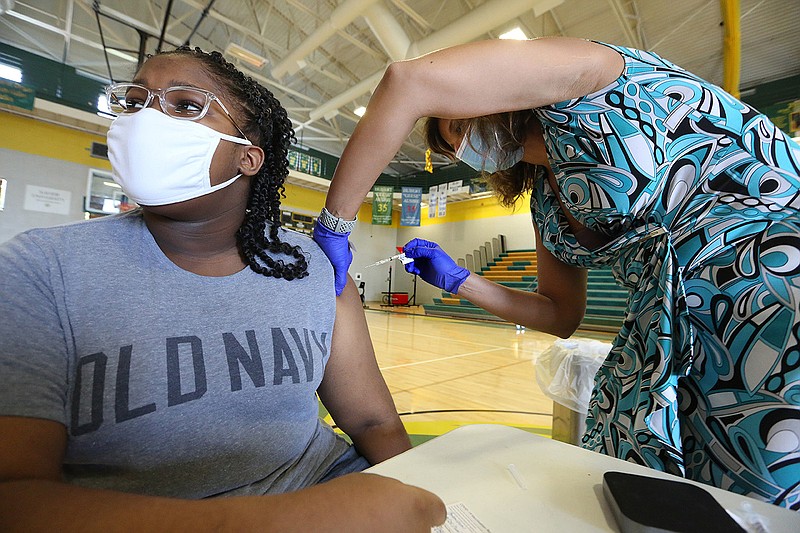 Janessa Johnson, 13, gets her covid-19 Pfizer vaccine shot from nurse practitioner Barbara McDonald at the University of Arkansas for Medical Sciences’ vaccination clinic Friday at Philander Smith College in Little Rock.
(Arkansas Democrat-Gazette/Thomas Metthe)