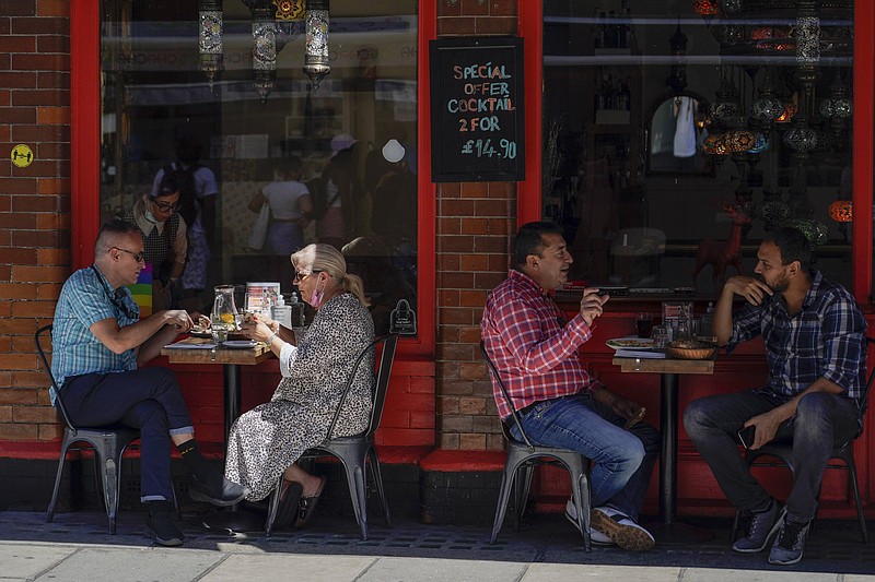 People sit at outdoor tables at a restaurant in London’s Soho area earlier this week. Retail sales in Britain rebounded in May as people ventured out to restaurants and pubs after coronavirus restrictions were eased.
(AP/Alberto Pezzali)