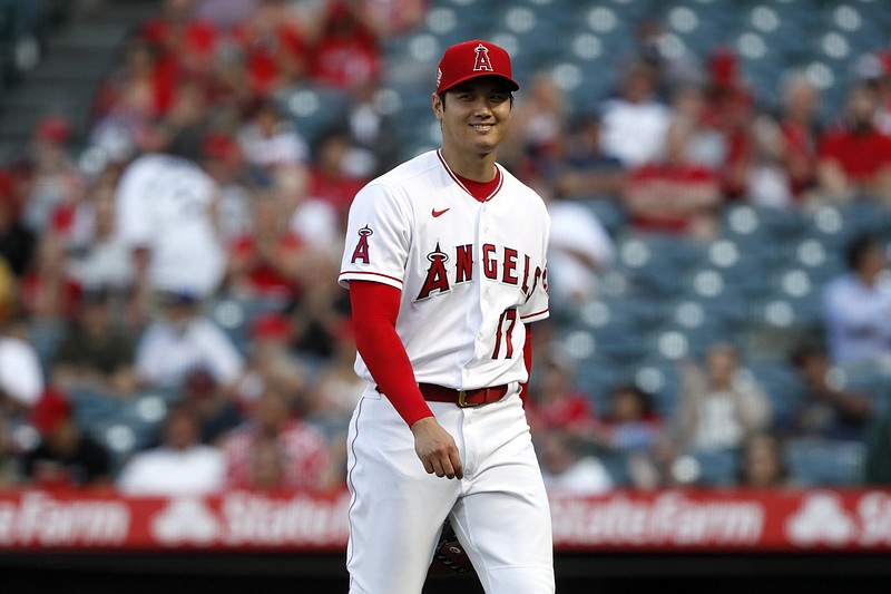 Los Angeles Angels starting pitcher Shohei Ohtani smiles as he leaves the field against Detroit Tigers during the first inning of a baseball game in Anaheim, Calif., Thursday, June 17, 2021. (AP Photo/Alex Gallardo)