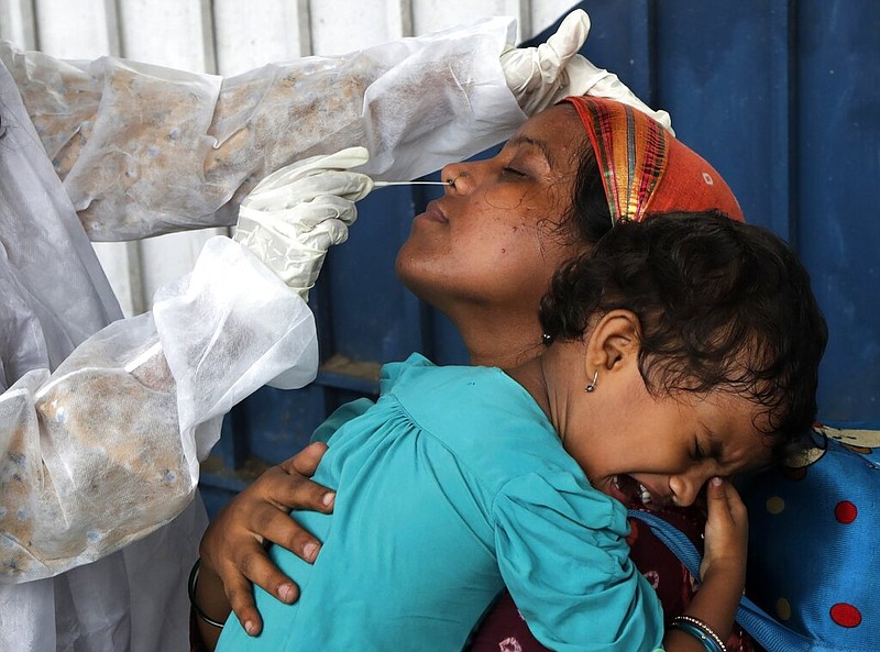 A traveler is tested for the coronavirus Thursday at a train station in Mumbai, India.
(AP/Rajanish Kakade)