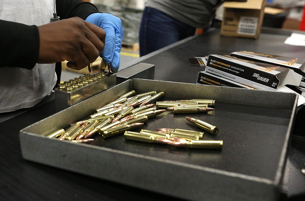 A Sig Sauer employee loads new ammunition into boxes at the company’s plant in Jacksonville.
(Arkansas Democrat-Gazette/Thomas Metthe)