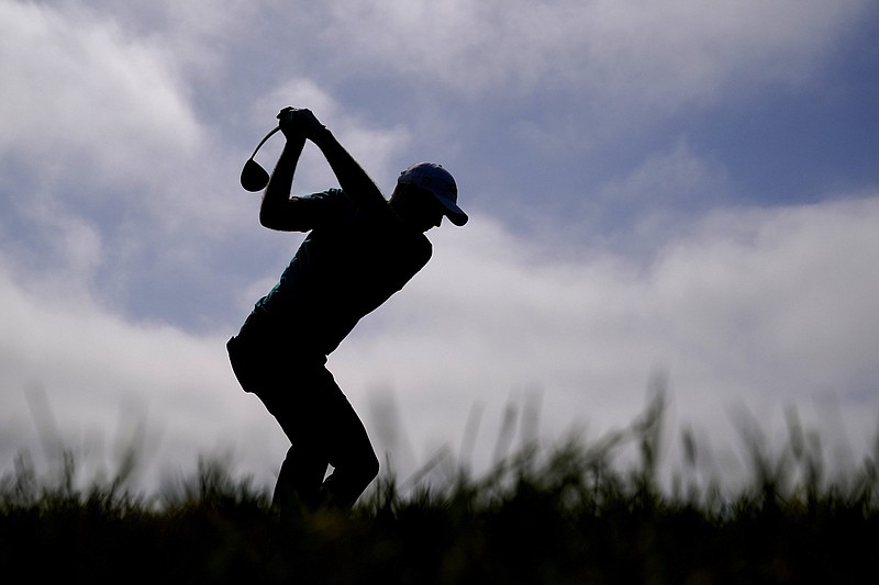 American Russell Henley hits from the 12th tee Saturday during the third round of the U.S. Open at Torrey Pines Golf Course in San Diego. Henley shot an even-par 71 on Saturday and shares the lead with Mackenzie Hughes and Louis Oosthuizen entering today’s final round. More photos available at arkansasonline.com/620open.
(AP/Jae C. Hong)