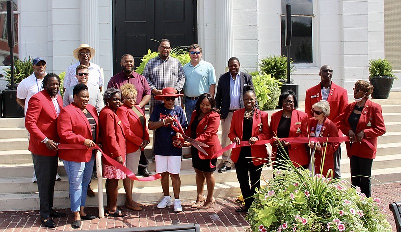 Pine Bluff Mayor Shirley Washington cuts the ribbon during the Streetscape ribbon-cutting ceremony Saturday in front of the Jefferson County Courthouse on Barraque Street. 
(Pine Bluff Commercial/Eplunus Colvin)