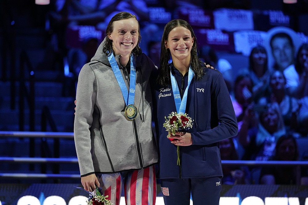 Katie Ledecky (left) and Katie Grimes on the podium at the medal ceremony for the women's 800 freestyle during wave 2 of the U.S. Olympic Swim Trials on Saturday, June 19, 2021, in Omaha, Neb. (AP Photo/Charlie Neibergall)