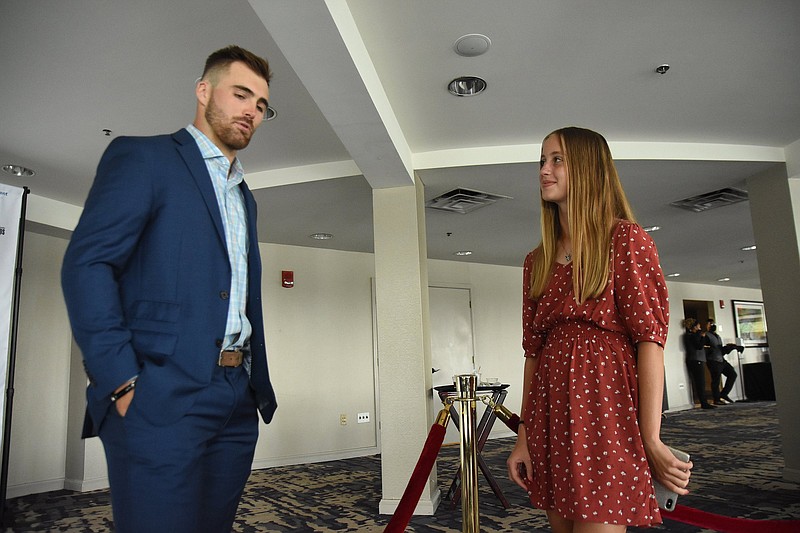 Buffalo Bills quarterback Jake Fromm (left) talks with Devyn O’Daniel, a Class 6A All-State cross country honoree from Bentonville, before the All-Arkansas Preps Awards Banquet on Saturday at the Statehouse Convention Center in Little Rock. Fromm was the the keynote speaker at the ninth annual event.
(Arkansas Democrat-Gazette/Staci Vandagriff)