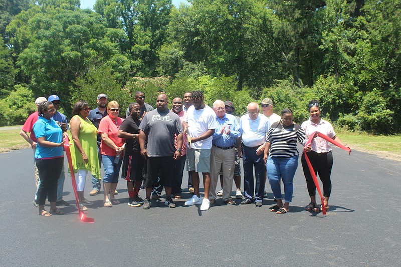 Smackover Chamber members gathered with MLK Park fundraisers and city officials to cut the ribbon to celebrate ongoing renovations to the central basketball court at the park. Fundraising organizer Neil Richardson was given the task of cutting the ribbon. (Matt Hutcheson/News-Times)