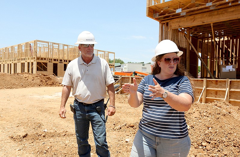 Sarah King, communications manager at Specialized Real Estate Group, and Shaun Brock, project superintendent with Huffman and Co., discuss the amenities that will be available at the South Yard as they walk through a phase of the apartment construction Thursday on the site in Fayetteville. More photos at arkansasonline.com/620yard/.
(NWA Democrat-Gazette/David Gottschalk)