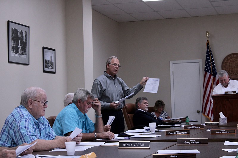 Bruce Johanson, standing, gives a presentation on the Johanson Group’s findings in a recent salary survey undertaken by Union County this spring. (Caitlan Butler/News-Times)