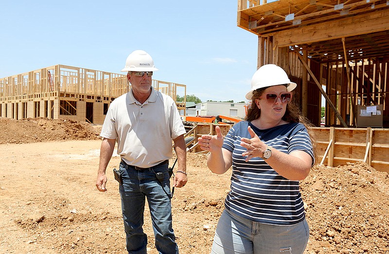 Sarah King (right), communications manager at Specialized Real Estate Group, and Shaun Brock, project superintendent with Huffman and Company, discuss the amenities Thursday that will be available at South Yard as they walk through a phase of the development on the site in south Fayetteville. The project lies between elements of the city’s U.S. 71B corridor project to the east and the University of Arkansas Windgate Art and Design District to the west, and plans to open apartments for lease early next year. Check out nwaonline.com/210620Daily/ and nwadg.com/photos for a photo gallery.

(NWA Democrat-Gazette/David Gottschalk)
