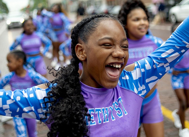 Lexi Watson, 10, shouts with joy Saturday in Flint, Mich., as she marches with the elite Amethyst dance company in one of two Juneteenth parades along Saginaw Street in the city’s downtown.
(AP/MLive.com/The Flint Journal/Jake May)