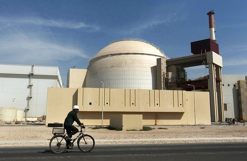 FILE - In this Oct. 26, 2010 file photo, a worker rides a bicycle in front of the reactor building of the Bushehr nuclear power plant, just outside the southern city of Bushehr. Iran’s sole nuclear power plant has undergone a temporary emergency shutdown, state TV reported on Sunday, June 20, 2021. An official from the state electric energy company, Gholamali Rakhshanimehr, said on a talk show that the Bushehr plant shutdown began on Saturday and would last "for three to four days.” (AP Photo/Mehr News Agency, Majid Asgaripour, File)