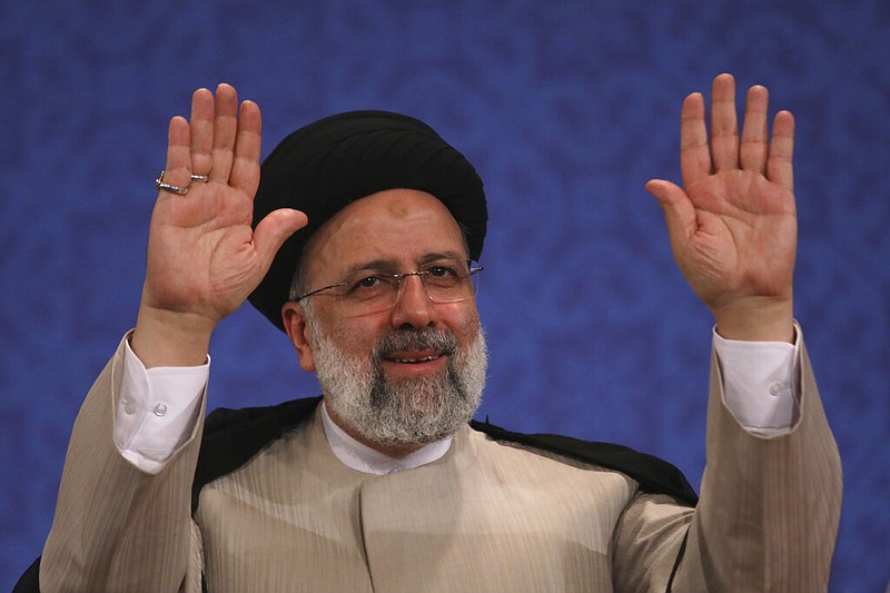 Iran's new President-elect Ebrahim Raisi waves to participants at the conclusion of his press conference in Tehran, Iran, Monday, June 21, 2021. Raisi said Monday he wouldn't meet with President Joe Biden nor negotiate over Tehran's ballistic missile program and its support of regional militias, sticking to a hard-line position following his landslide victory in last week's election. (AP Photo/Vahid Salemi)