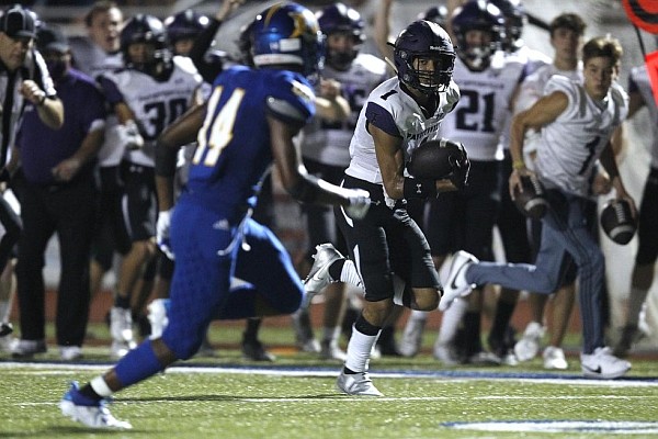 Fayetteville wide receiver Isaiah Sategna (1) runs the ball during the third quarter of Fayetteville's 35-17 loss to North Little Rock on Friday, Sept. 11, 2020, at North Little Rock High School.