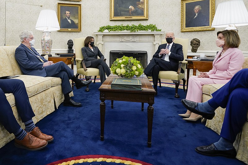 FILE - In this May 12, 2021, file photo President Joe Biden speaks during a meeting with congressional leaders in the Oval Office of the White House in Washington. From left, House Minority Leader Kevin McCarthy of Calif., Senate Minority Leader Mitch McConnell of Ky., Vice President Kamala, Biden, House Speaker Nancy Pelosi of Calif., and Senate Majority Leader Chuck Schumer of N.Y. Congress is hunkered down, grinding through an eight-week stretch as the president’s Democratic allies in the House and Senate try to shape his big infrastructure ideas into bills that could actually be signed into law. Perhaps not since the drafting of Obamacare more than a decade ago has Washington tried a legislative lift as heavy as this. (AP Photo/Evan Vucci, File)