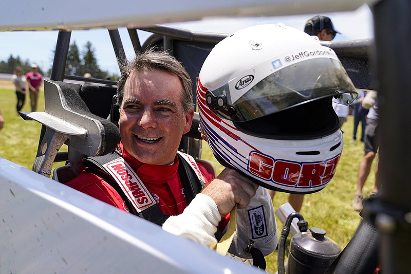 Jeff Gordon, a five-time winner of the Brickyard 400 and four-time NASCAR Cup Series champion, prepares to drive a USAC midget car during an exhibition on the dirt track in the infield at Indianapolis Motor Speedway in Indianapolis, Thursday, June 17, 2021. (AP Photo/Michael Conroy)