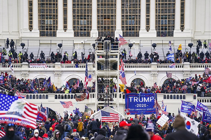 People loyal to President Donald Trump breach the Capitol in Washington during a riot in this Jan. 6, 2021 file photo. (AP/John Minchillo)