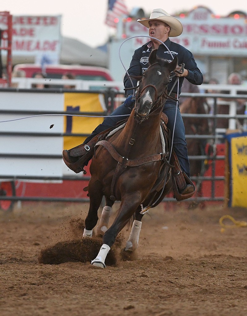 Wyatt Imus competes in the team roping event Thursday at the Rodeo of the Ozarks in Springdale. Imus and partner Caleb Anderson had the lowest score with a 5.8, which placed them in the top four overall heading into today’s competition. More photos at arkansasonline.com/625rodeoday2/
(NWA Democrat-Gazette/J.T. Wampler)