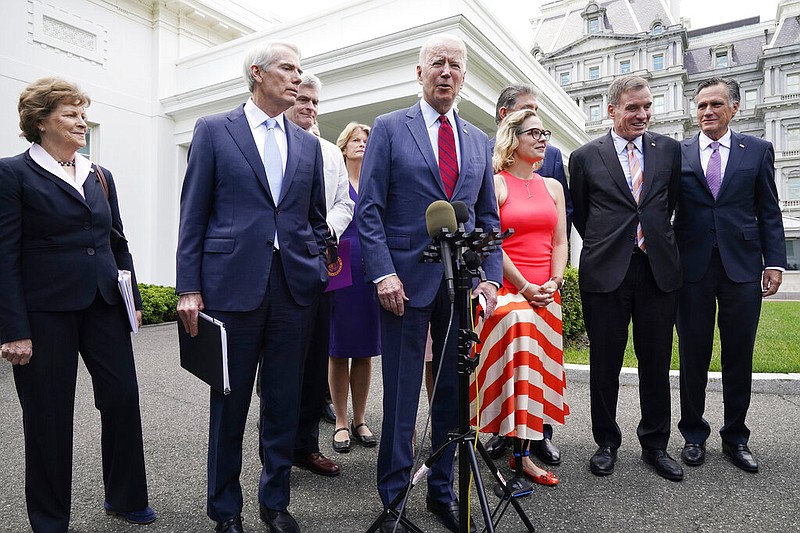 President Joe Biden, with a bipartisan group of senators, speaks Thursday June 24, 2021, outside the White House in Washington. Biden invited members of the group of 21 Republican and Democratic senators to discuss the infrastructure plan. (AP/Jacquelyn Martin)