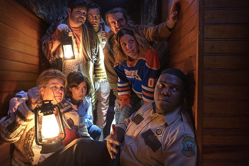 Probably die in a small town: (from left) Jeanine (Catherine Curtin), Cecily (Milana Vayntrub), Joaquim (Harvey Guillen), Devon (Cheyenne Jackson), Marcus (George Basil), Gwen (Sarah Burns) and Finn (Sam Richardson) try to survive a werewolf attack in the horror comedy “Werewolves Within.”