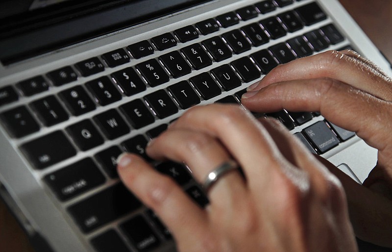 A person types on a laptop keyboard in this June 19, 2017, file photo. (AP/Elise Amendola)