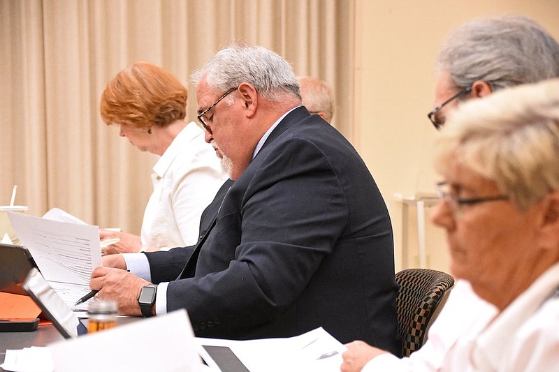 Andy Altom, board chair of the Child Welfare Agency Review Board, and other board members review the agenda for request of alternative compliance during the meeting Thursday, June 24, 2021 at the Department of Human Services in Little Rock.
(Arkansas Democrat-Gazette/Staci Vandagriff)