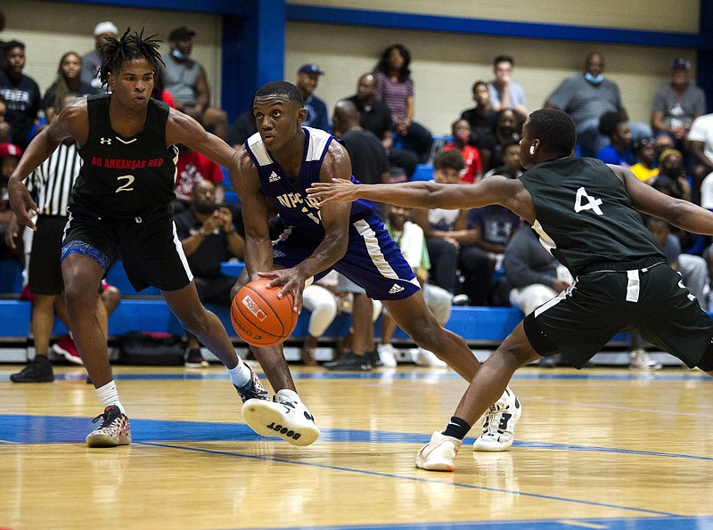 Derrian Ford, center, from NP Force, drives through the All Arkansas Red defense during the Real Deal in the Rock 17U Championship game on Sunday, June 27, 2021. See more photos at arkansasonline.com/628basketball/..(Arkansas Democrat-Gazette/Stephen Swofford)