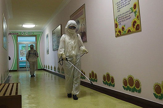 Workers disinfect the Pyongyang Primary School No. 4 on Wednesday in Pyongyang, North Korea. Officials contend there have been no coronavirus infections in the country, despite testing thousands of people and sharing a porous border with China.
(AP/Cha Song Ho)