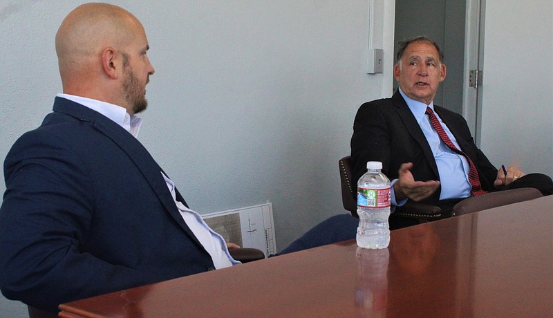 Senator John Boozman visited El Dorado Tuesday as part of a tour of southwest Arkansas. Sen. Boozman met with a small group of local officials and industry heads at the South Arkansas Regional Airport to discuss issues pertaining to water and sewer and other infrastructure, regulations, construction costs and broadband access. Boozman is pictured speaking with State Senator Trent Garner. (Matt Hutcheson/New-Times)