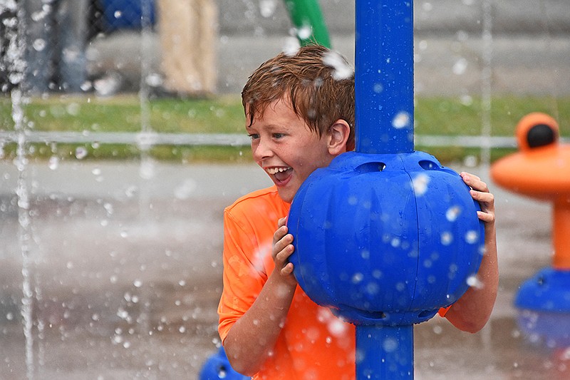 Ian Jaques, 8, plays at the Maumelle Splash Pad during its opening day Thursday, July 1, 2021 next to the Maumelle Public Library. The splash pad will be open from 9 a.m. to 8 p.m. daily until October, weather permitting. See more photos at arkansasonline.com/72splashpad/..(Arkansas Democrat-Gazette/Staci Vandagriff)