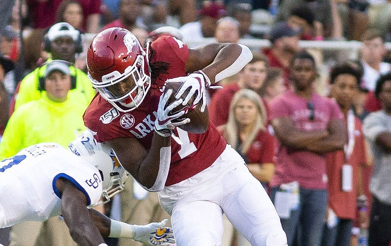 Arkansas wide receiver Trey Knox became the fi rst Razorback to announce an endorsement deal as the NCAA first allowed student-athletes to profit from their names, images and likenesses. Knox’s endorsement is with PetSmart, which will feature Knox and his husky dog, Blue.
(Special to the NWA Democrat-Gazette/David Beach)