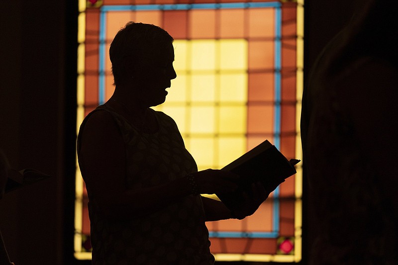 A member of Waldoboro United Methodist Church sings a hymn during a service June 20 in Waldoboro, Maine. The drop in attendance at the church, in part due to covid-19, forced its closure.
(AP/Robert F. Bukaty)