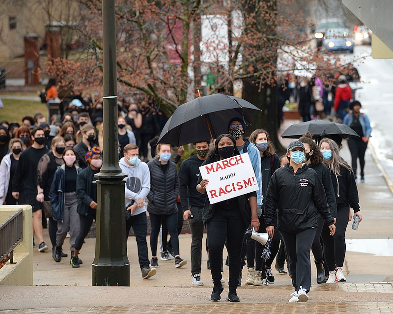 University of Arkansas students and members of the campus community participate in a march on March 13 during an anti-racism rally to express support for the campus to disassociate from J. William Fulbright and Charles Brough, who have been criticized for stances taken against civil rights and in support of white landowners after racial violence against Black citizens.
(NWA Democrat-Gazette/Andy Shupe)