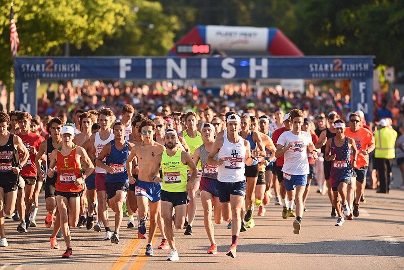 Participants in the Firecracker 5K take off from the starting line on S. Monroe Street on Sunday, July 4, 2021 in Little Rock. See more photos at arkansasonline.com/75firecracker5k/..(Arkansas Democrat-Gazette/Staci Vandagriff)