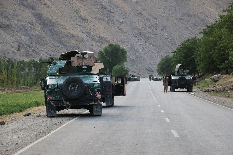 Afghan soldiers pause on a road at the front line of fighting between Taliban and Security forces,  near the city of Badakhshan, northern Afghanistan, Sunday, July. 4, 2021. Officials said Sunday that the Talibanâ€™s march through northern Afghanistan has gained momentum with the capture of several districts from fleeing Afghan forces. They said that several hundred of them fled across the border into Tajikistan.(AP Photo/Nazim Qasmy)