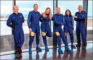 This image provided by Virgin Galactic shows, from left: Chief Pilot Dave Mackay, Lead Operations Engineer Colin Bennett, Chief Astronaut Instructor Beth Moses, Founder of Virgin Galactic Richard Branson, Vice President of Government Affairs and Research Operations Sirisha Bandla and pilot Michael Masucci. Branson is aiming to beat fellow billionaire Jeff Bezos into space by nine days. Branson’s company announced Thursday, July 1, 2021 that its next test flight will be July 11 and that its founder will be among the six people on board. The winged rocket ship will soar from New Mexico _ the first carrying a full crew of company employees. It will be only the fourth trip to space for Virgin Galactic. (Virgin Galactic via AP)