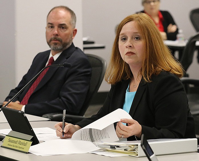 State Board of Finance members Cale Turner and Susannah Mar- shall listen to a staff member during the board’s meeting Wednesday in Little Rock.
(Arkansas Democrat-Gazette/Thomas Metthe)